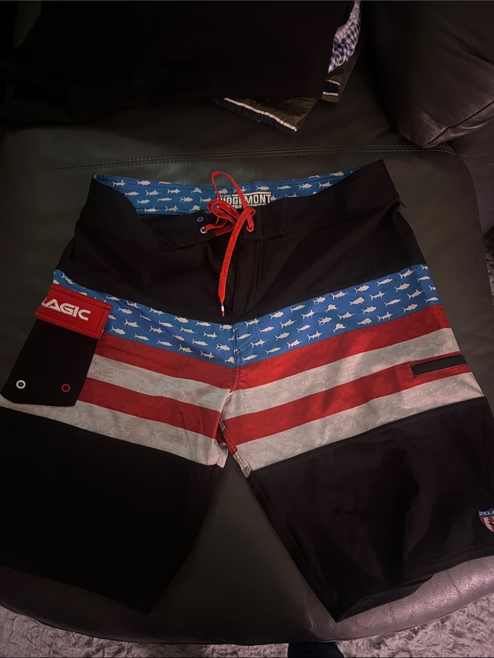 Pelagic Black Board Shorts with Red, Blue, and White Flag Stripe